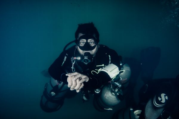 scuba expert doing scuba diving in Pondicherry clicking an underwater photo with OLYMPUS DIGITAL CAMERA at temple adventure Technical fun dive